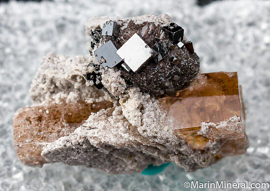 Bixbyite on Hematite after Garnet on Topaz