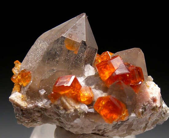 Spessartine on and in Quartz