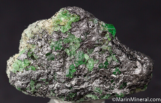 Tsavorite with Pyrite on Graphite