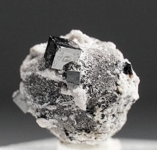Bixbyite on Hematite pseudo. Garnet