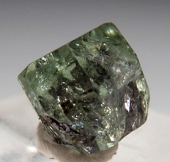 Tsavorite included by Graphite